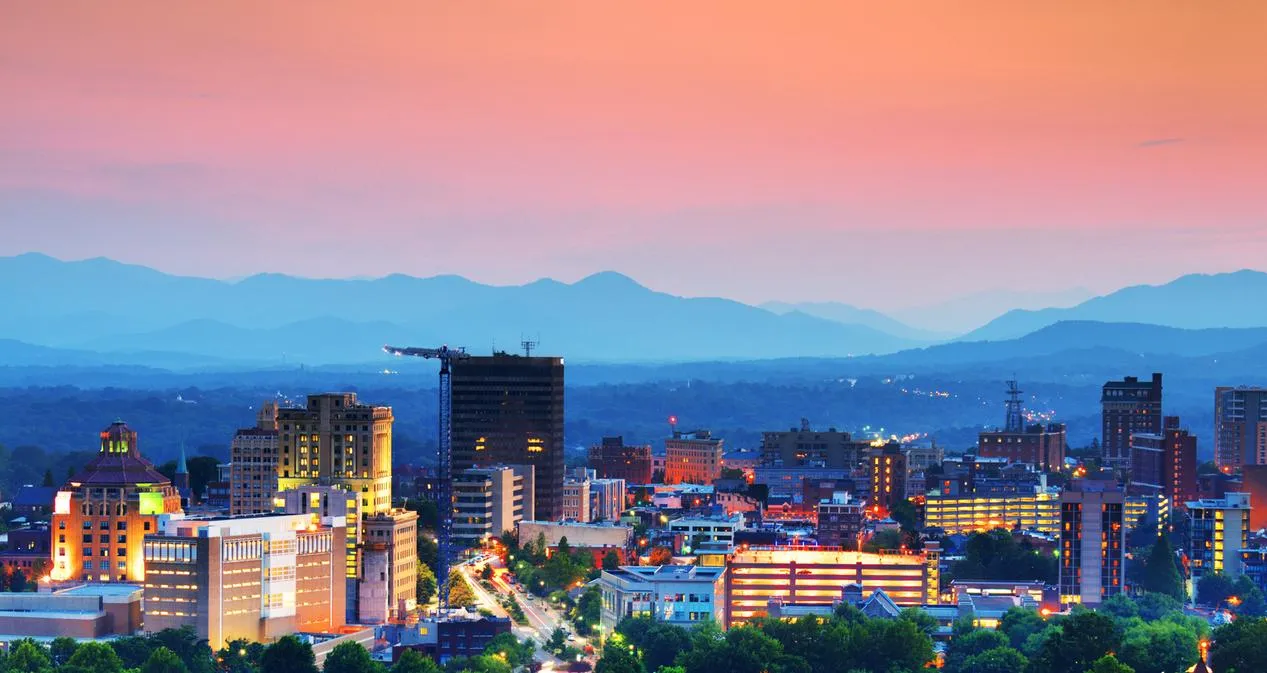 City skyline with mountains at sunset